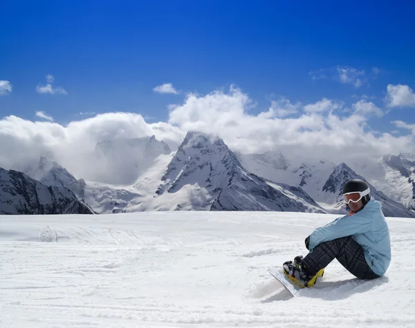 Snowboarder resting on the ski slope Stock Photo