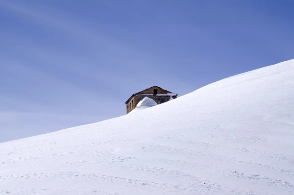 A velha casa de tijolo no meio da pista de esqui — Fotografia de Stock