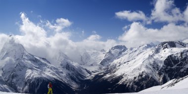 Panorama Caucasus Mountains. Slope with skier. clipart