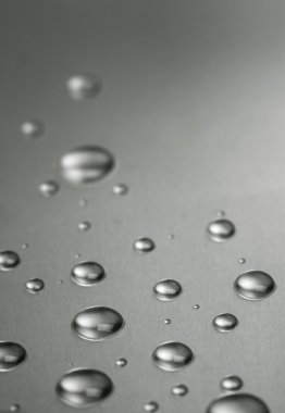 Quicksilver. Abstract still-life with liquid droplets over steel clipart