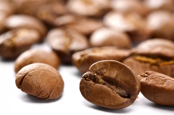 Coffee beans closeup over white backgrounds — Stock Photo, Image