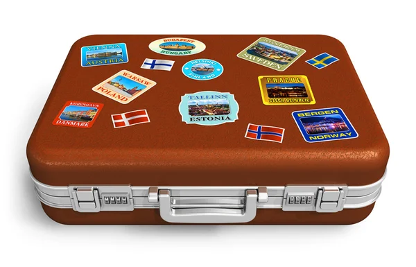 Leather travel suitcase with labels — Stock Photo, Image