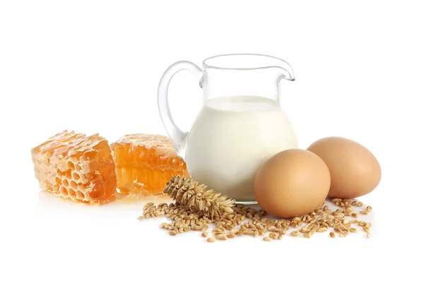 Milk, wheat seeds, eggs and honey — Stock Photo, Image