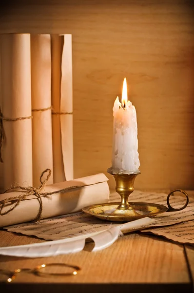 Antic candle with rool of paper — Stock Photo, Image