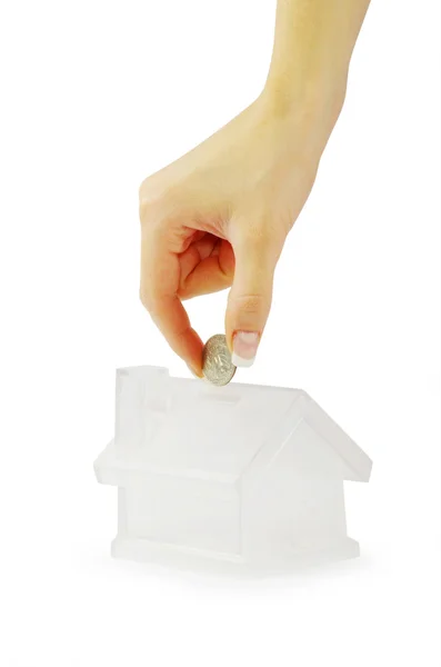 Hand with coin and house — Stock Photo, Image