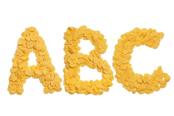 Abc letras feitas de flocos de milho sobre fundo branco — Fotografia de Stock