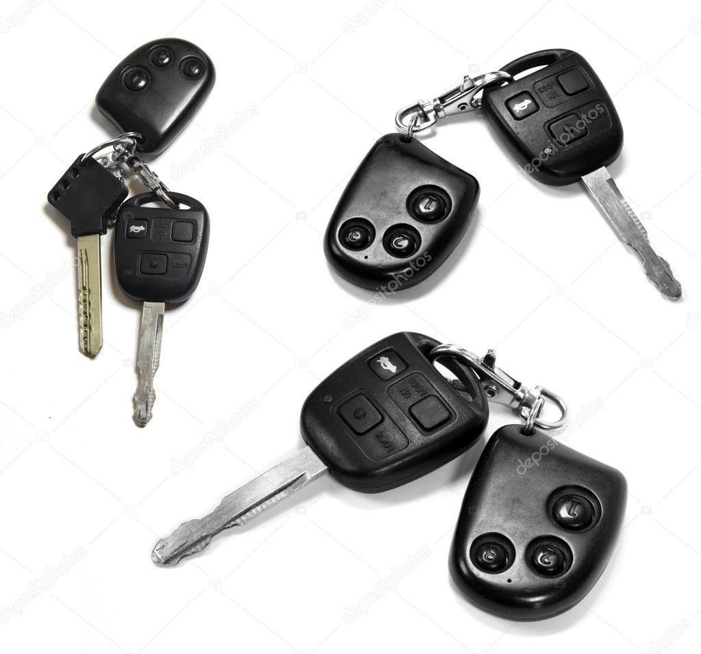 Car keys with remotes on white background
