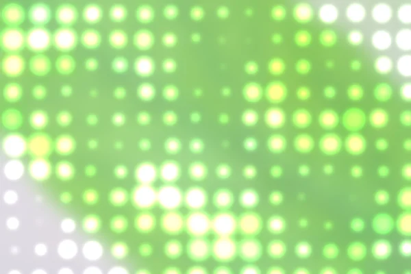 Achtergrond met uit focus licht stippen in het groen — Stockfoto