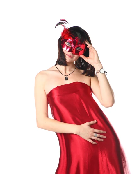 Kvinna klädd i röd klänning och en mask — Stockfoto