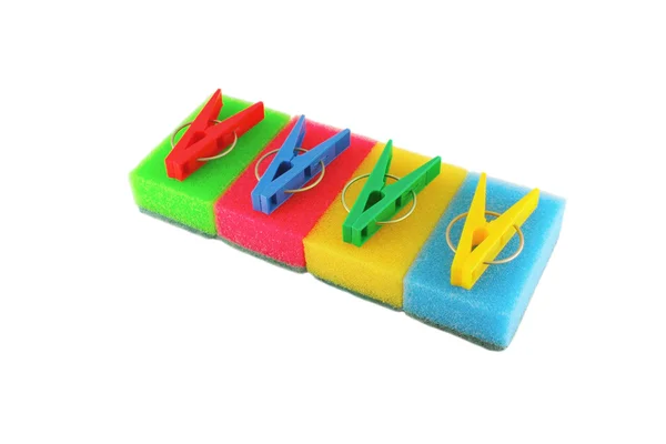Color sponges and clothes-pegs over white — Stock Photo, Image