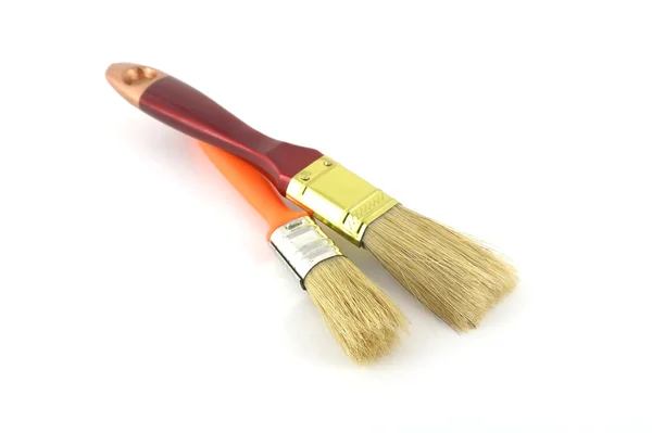Duas escovas de tinta com alças marrom e laranja — Fotografia de Stock