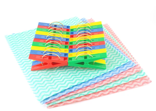 Color clothes-pegs on the color napkins — Stock Photo, Image