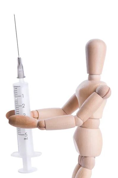 Wooden person holds a syringe — Stock Photo, Image