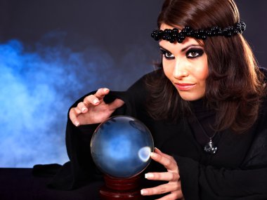 Young woman with crystal ball. clipart