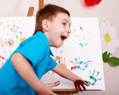 Child with easel draw hands. clipart