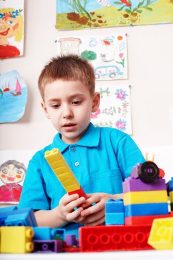 Child playing block and construction set. clipart