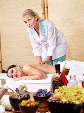 Young woman on massage table in beauty spa. clipart