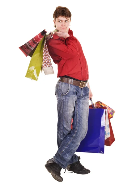 Lycklig man i jeans med shopping väska. — Stockfoto