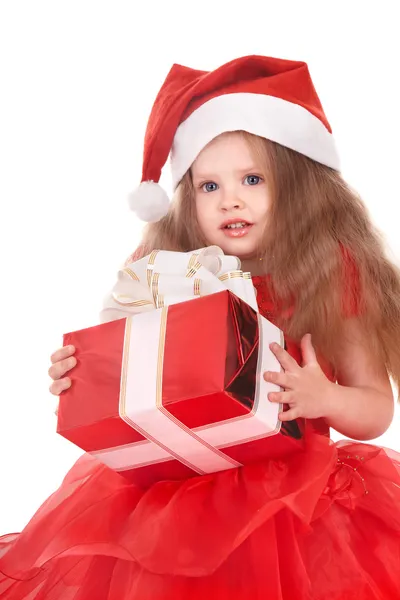 Child in santa hat holding red gift box. — Stock Photo, Image