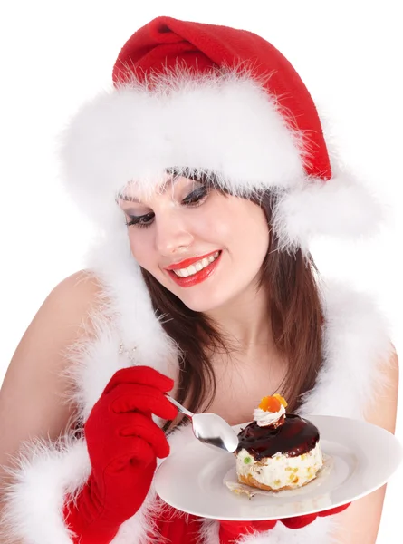 Різдвяна дівчина в капелюсі Санта їсть торт  . — стокове фото