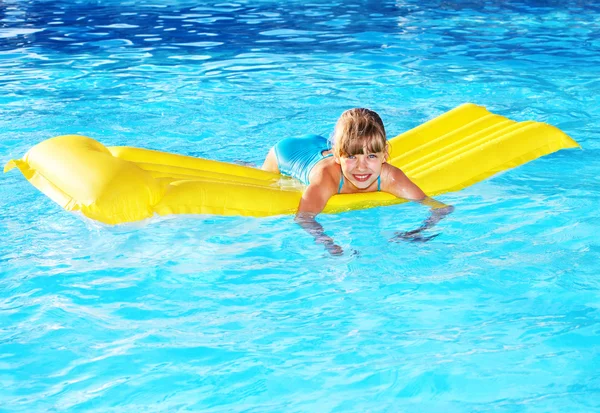 stock image Child swimming on inflatable beach mattress.