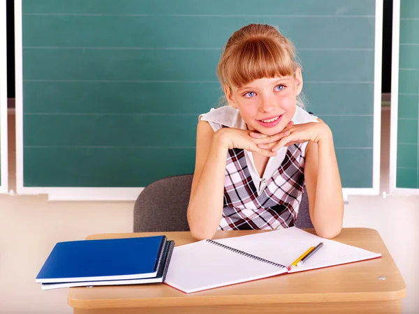 Schoolchild in classroom near blackboard. — Stock Photo, Image