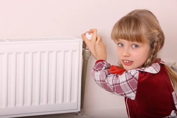 stock image Girl try open thermostat. Crisis.