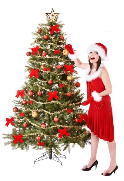 Girl in santa hat decorete christmas tree. Royalty Free Stock Images