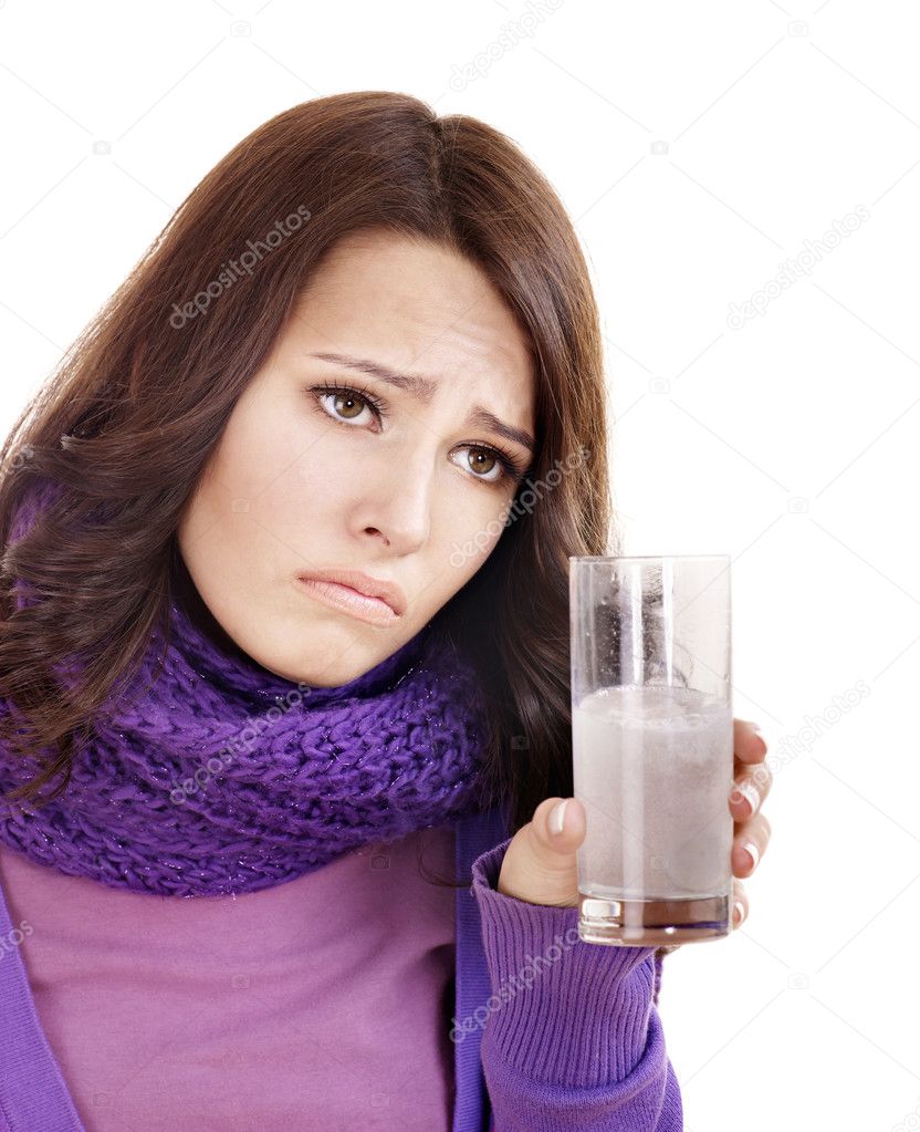 Girl holding glass of water and taking pills.