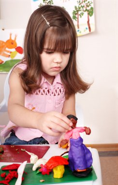 Child moulding of plasticine . clipart