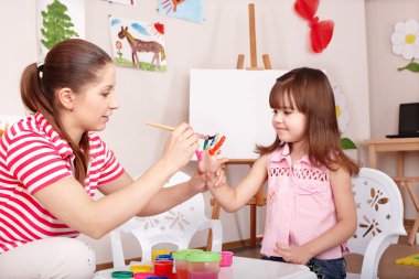 Child making handprints. clipart