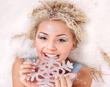 Young woman bite snowflake. clipart