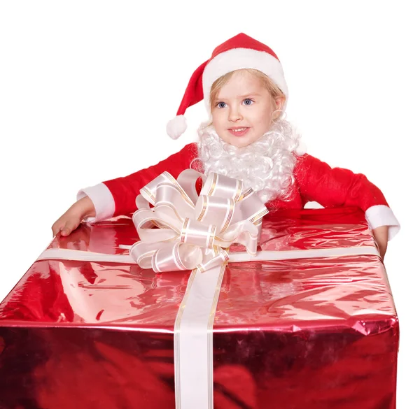 Child in santa hat giving gift box. — Stock Photo, Image