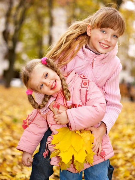 Kids in autumn orange leaves. — Stock Photo, Image