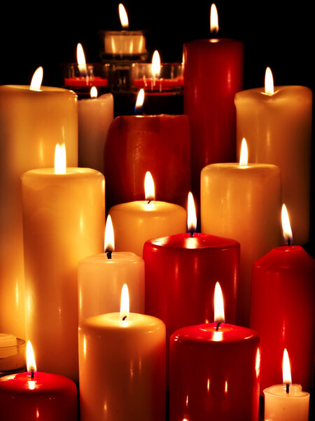 Group of candles on black background.