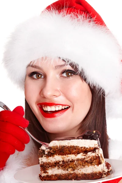 Weihnachtsmädchen mit Weihnachtsmütze und Kuchen auf Teller. — Stockfoto