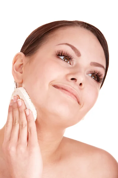 stock image Young woman washing her face by sponge.