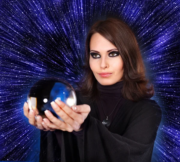 Girl with fortune telling ball against star sky. — Stock Photo, Image
