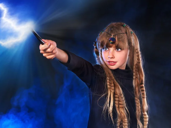 Girl in witch's hat with magic wand. — Stock Photo, Image