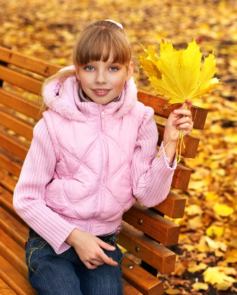 Kid in autumn orange leaves. — Stockfoto