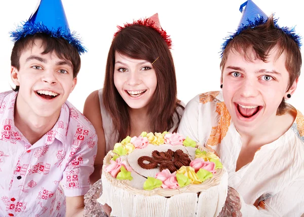 Groep in feest hoed eten taart. — Stockfoto