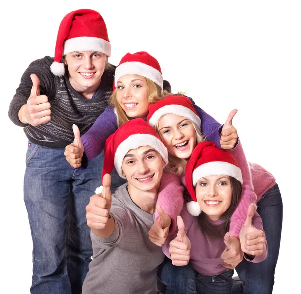 Grupp unga i santa hatt visar tummen upp. — Stockfoto