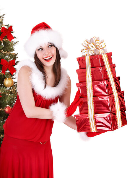 Christmas girl in santa hat holding stack gift box.