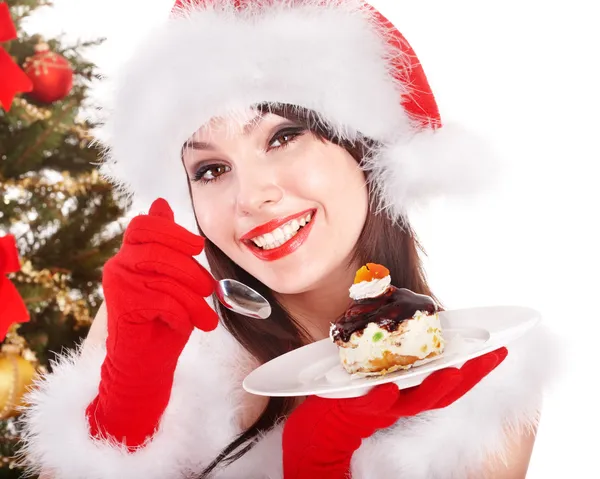 Navidad chica en santa hat comer pastel en plato . —  Fotos de Stock