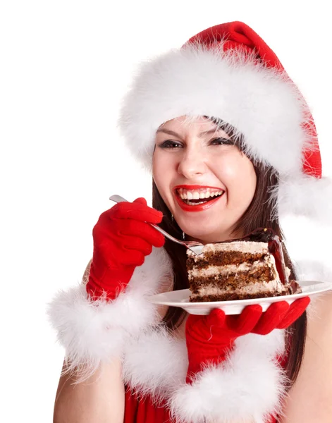Різдвяна дівчина в капелюсі Санта їсть торт на тарілці . — стокове фото