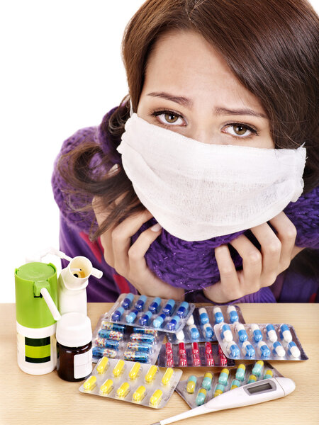 Girl having flu taking pills