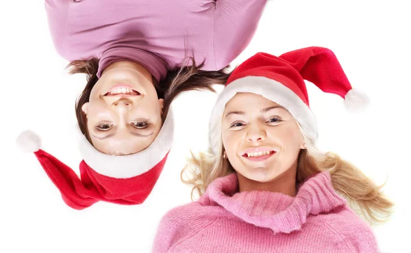 Girls in santa hat lying head next to head. — Stock Photo, Image
