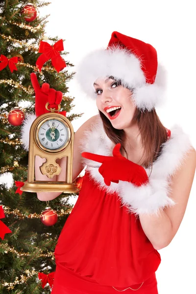 Kerstmis meisje in Kerstman hoed, bedrijf klok. — Stockfoto