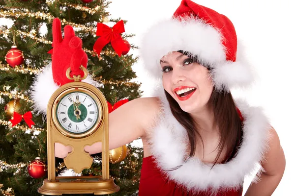 Christmas girl in santa hat and fir tree with alarm clock. — Stock Photo, Image