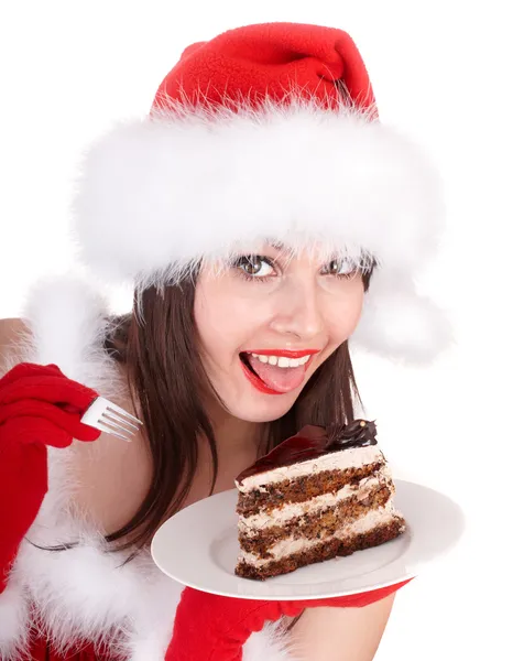Weihnachtsmädchen in roter Weihnachtsmütze und Kuchen auf Teller. — Stockfoto